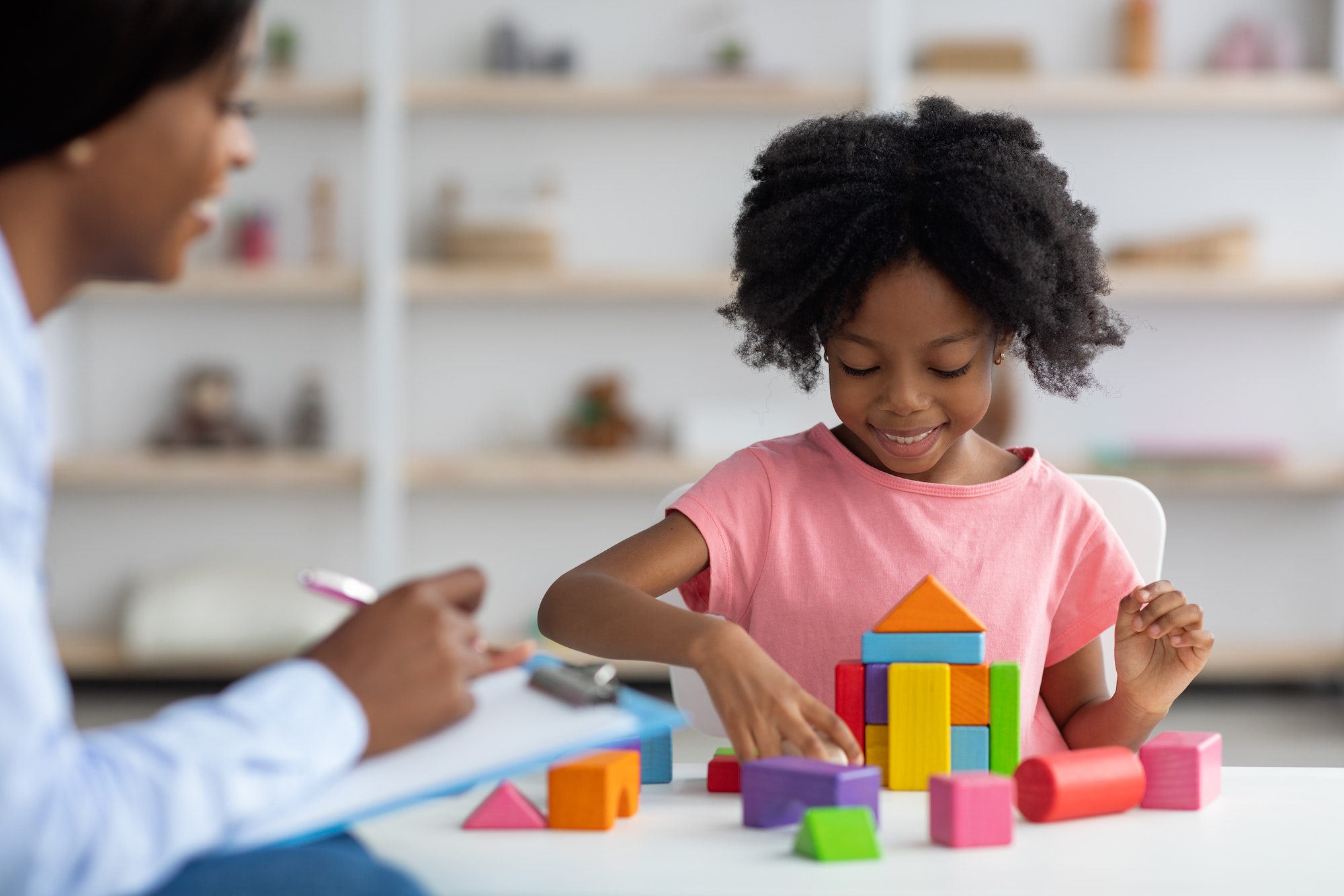 child-development-specialist-observing-cheerful-child-preschooler.jpg